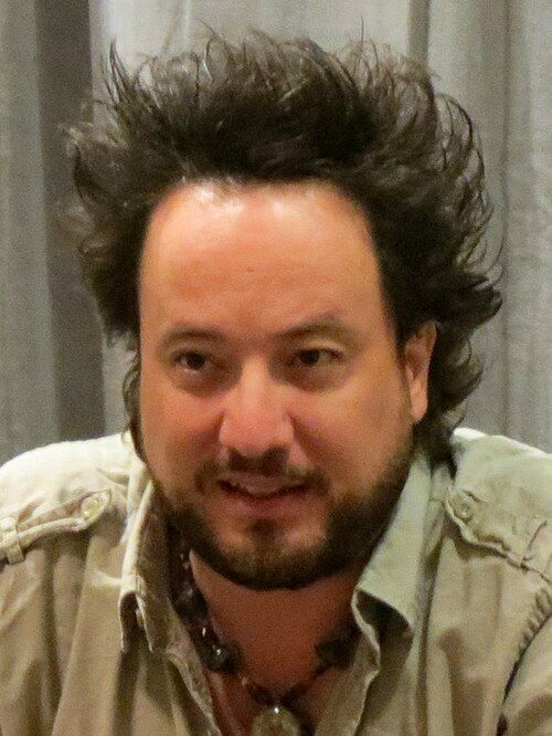 Giorgio Tsoukalos, smiling, his hair standing up in every direction.