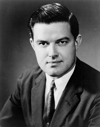 An official portrait of Senator Frank Church, a young man in a dark suit and tie.