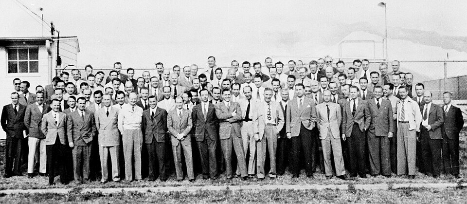 A large group photo of German rocket scientists standing in rows outdoors at Fort Bliss, Texas.