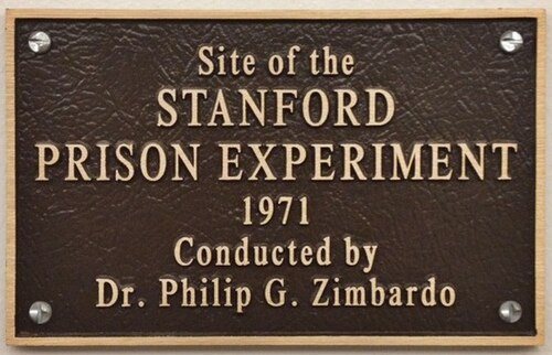 A bronze plaque reading: Site of the Stanford Prison Experiment, 1971, conducted by Dr. Philip G. Zimbardo.
