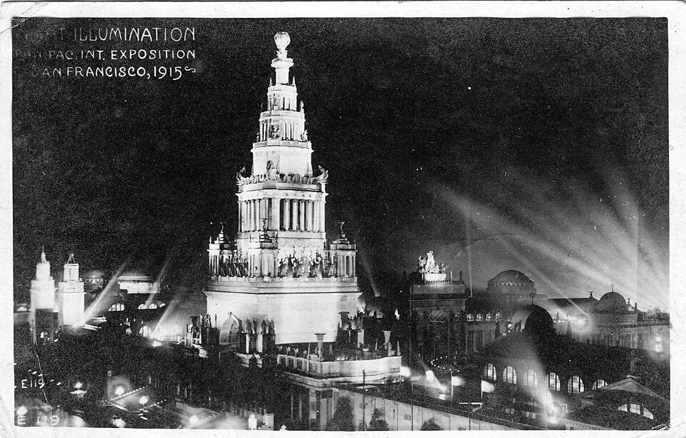 The Tower of Jewels at the 1915 Panama-Pacific International Exposition in San Francisco, lit up at night above a grand courtyard.